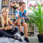 two-sexy-females-having-fun-with-virtual-reality-glasses-device-home_613910-10097